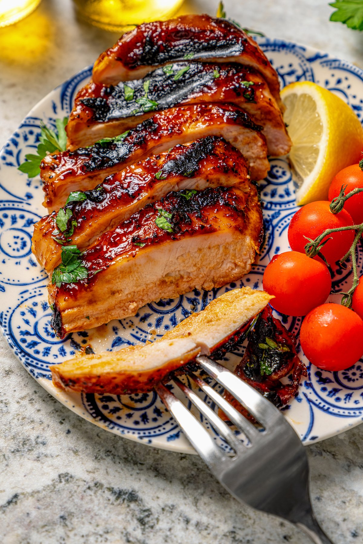 Juicy, sliced BBQ chicken recipe on a serving plate. 