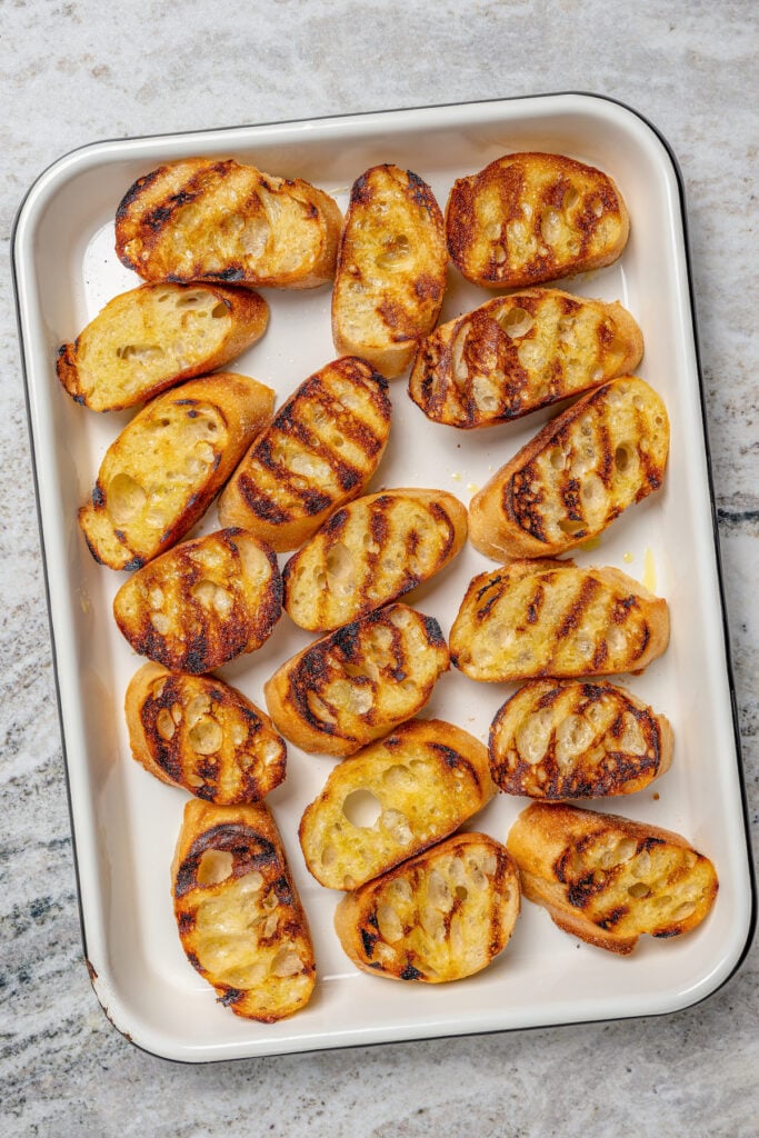 Toasty sliced bread on a baking sheet. 