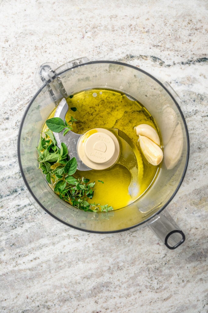 Adding the sauce ingredients to the food processor. 