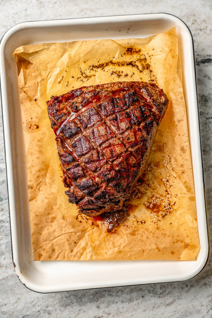 Whole grilled roast on a baking sheet. 