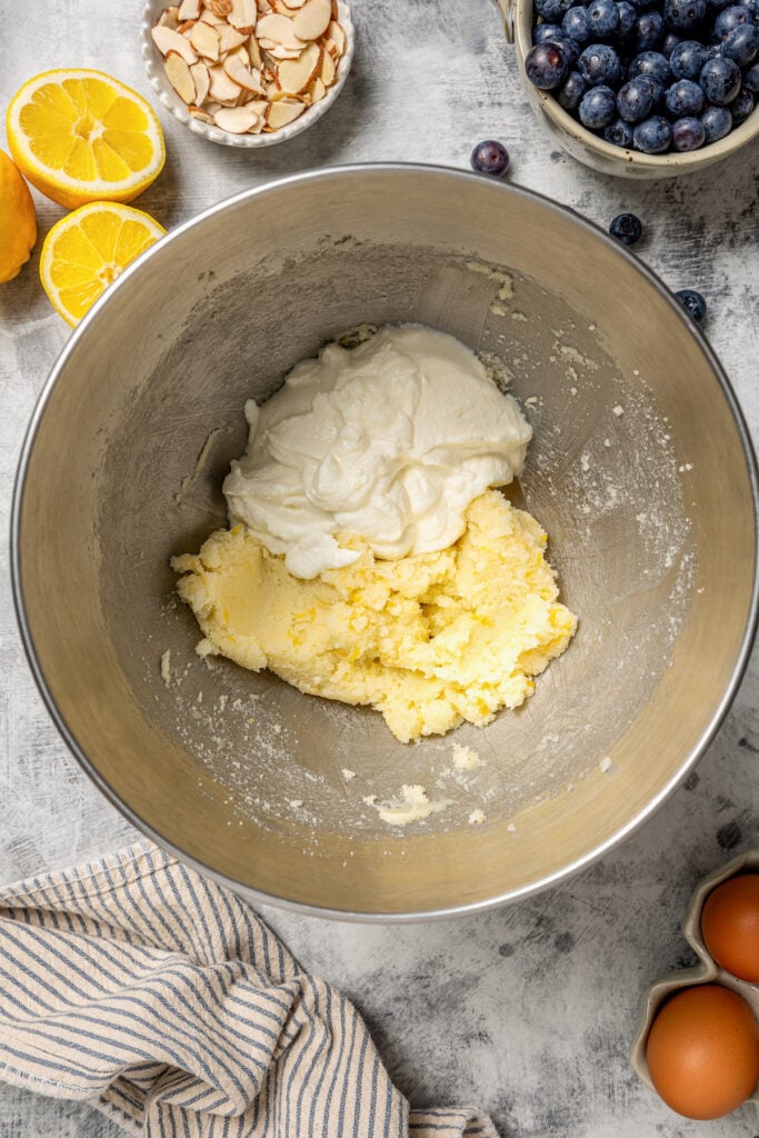 Adding the ricotta to the creamed butter.