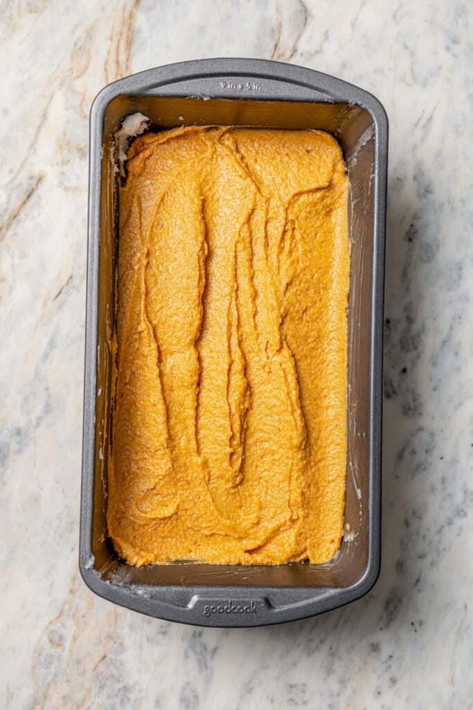 Pouring the batter into the loaf pan. 