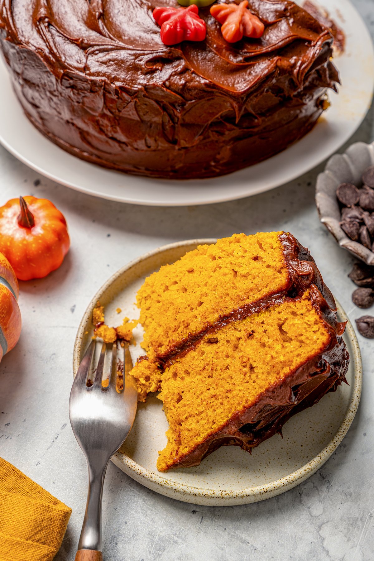 Digging into a slice of cake with fluffy chocolate frosting. 