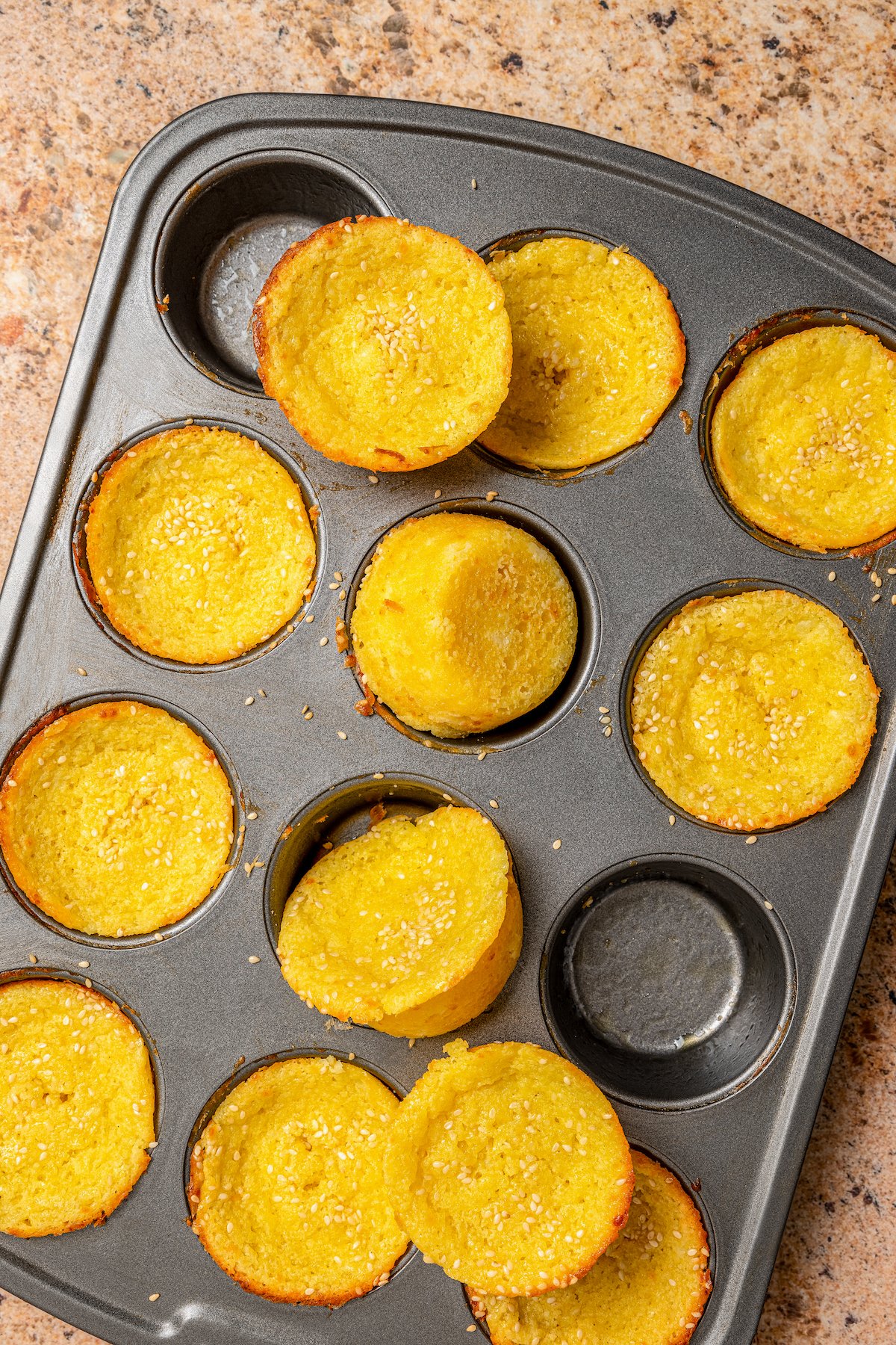 Baked quesadilla breakfast muffins with golden edges and crunchy sesame seeds. 